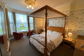 Premium room with a sea view and a king size four poster bed